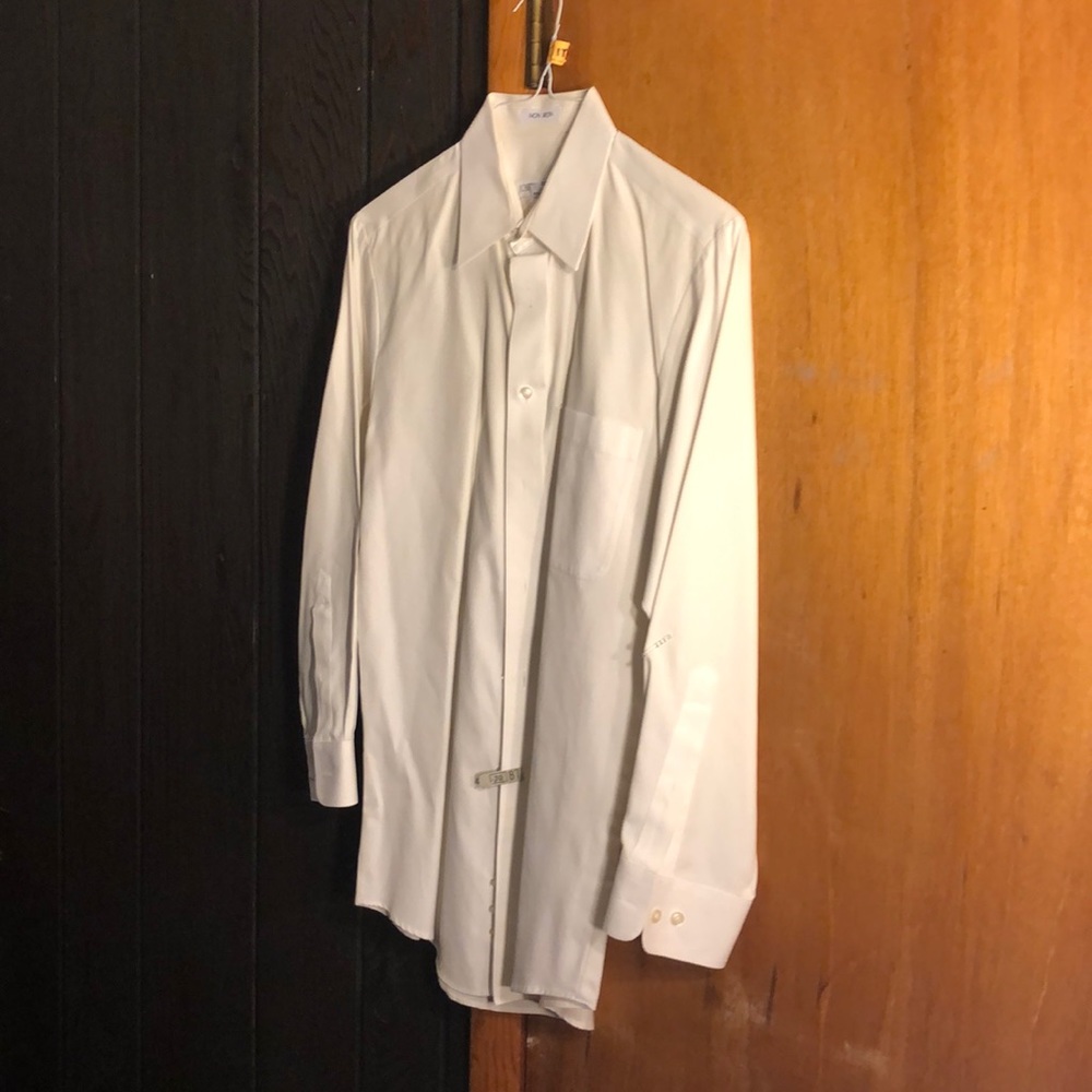 White button down dress shirt some signs of discoloration around collar.